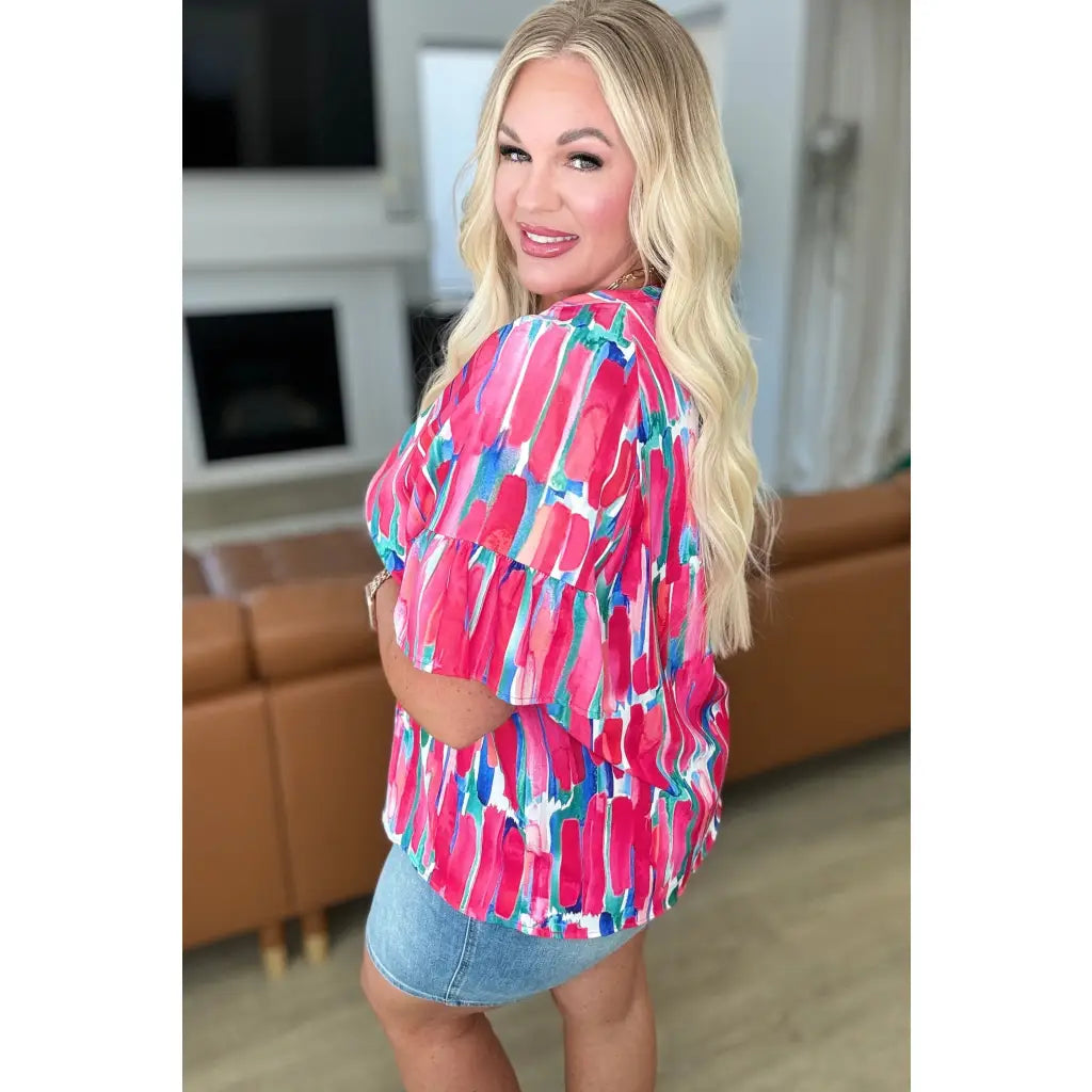 Show your bold side in the Abstract Art V-Neck Blouse plus. Hot pink magenta teal and white make it a standout.