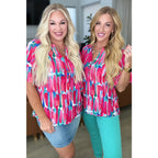 Show your bold side in the Abstract Art V-Neck Blouse plus. Hot pink magenta teal and white make it a standout.