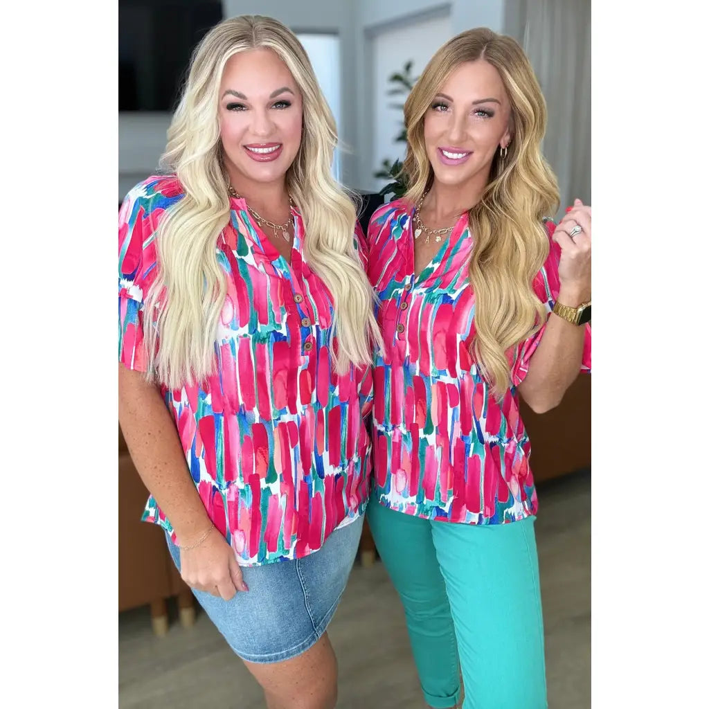 Show your bold side in the Abstract Art V-Neck Blouse plus. Hot pink magenta teal and white make it a standout.