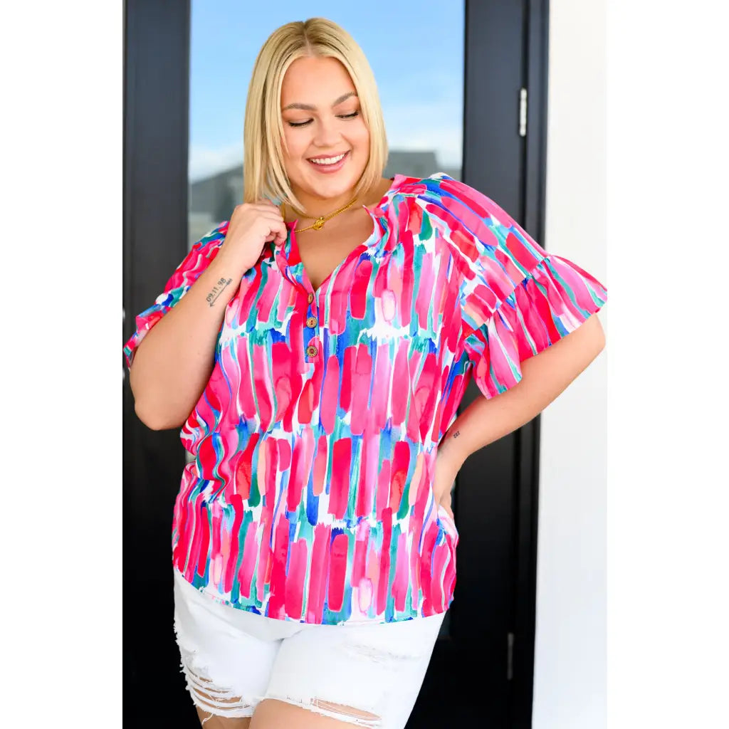 Show your bold side in the Abstract Art V-Neck Blouse plus. Hot pink magenta teal and white make it a standout.