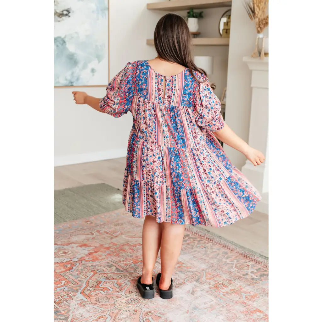 Shop this floral tiered mini dress with flowy fit and boho style. Available in standard plus sizes for a comfortable