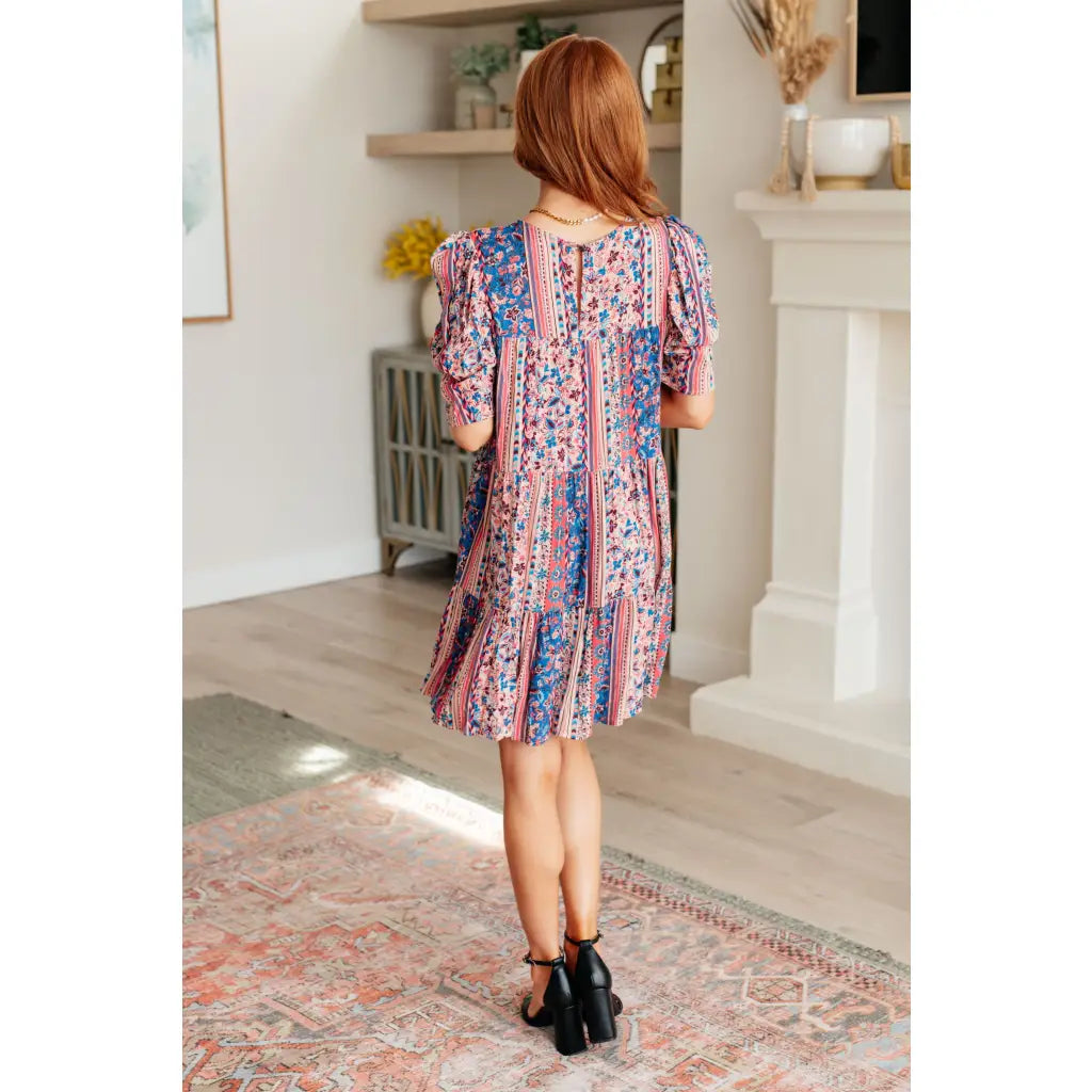 Shop this floral tiered mini dress with flowy fit and boho style. Available in standard plus sizes for a comfortable