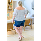 Shop the Serenity in Stripes Smocked Top. Blue and white cotton smocked fit puff sleeves boutique chic. Available