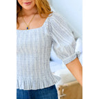 Shop the Serenity in Stripes Smocked Top. Blue and white cotton smocked fit puff sleeves boutique chic. Available