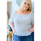 Shop the Serenity in Stripes Smocked Top. Blue and white cotton smocked fit puff sleeves boutique chic. Available