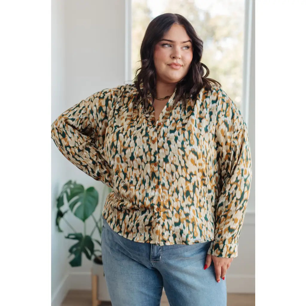 Satin button up blouse with amber and olive abstract print. Lightweight flowy fit that’s plus size office friendly.