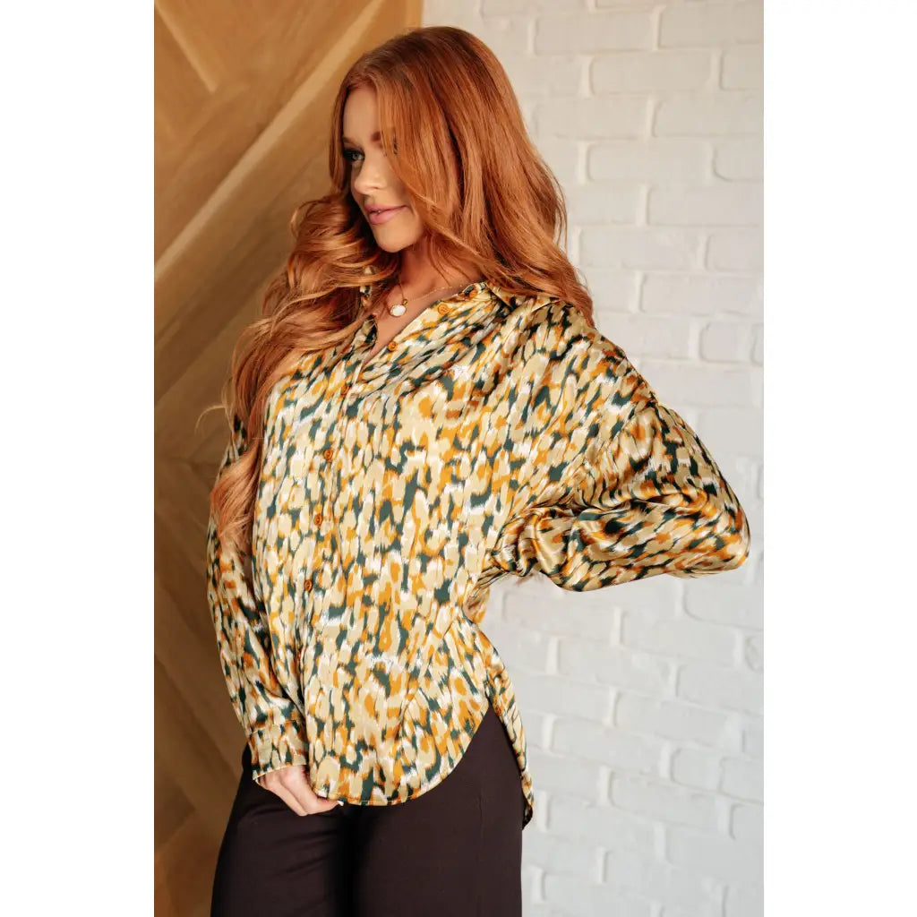 Satin button up blouse with amber and olive abstract print. Lightweight flowy fit that’s plus size office friendly.