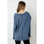 Get ready to cuddle up in our Basically Freezing V-Neck Top Dusty Blue! Its soft brushed hacci fabric and stretchy