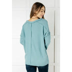 Get ready to cuddle up in our Basically Freezing V-Neck Top Dusty Teal! Its soft brushed hacci fabric and stretchy