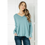 Get ready to cuddle up in our Basically Freezing V-Neck Top Dusty Teal! Its soft brushed hacci fabric and stretchy