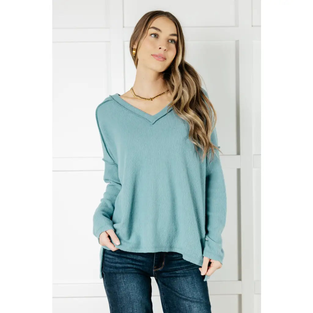 Get ready to cuddle up in our Basically Freezing V-Neck Top Dusty Teal! Its soft brushed hacci fabric and stretchy