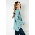 Get ready to cuddle up in our Basically Freezing V-Neck Top Dusty Teal! Its soft brushed hacci fabric and stretchy