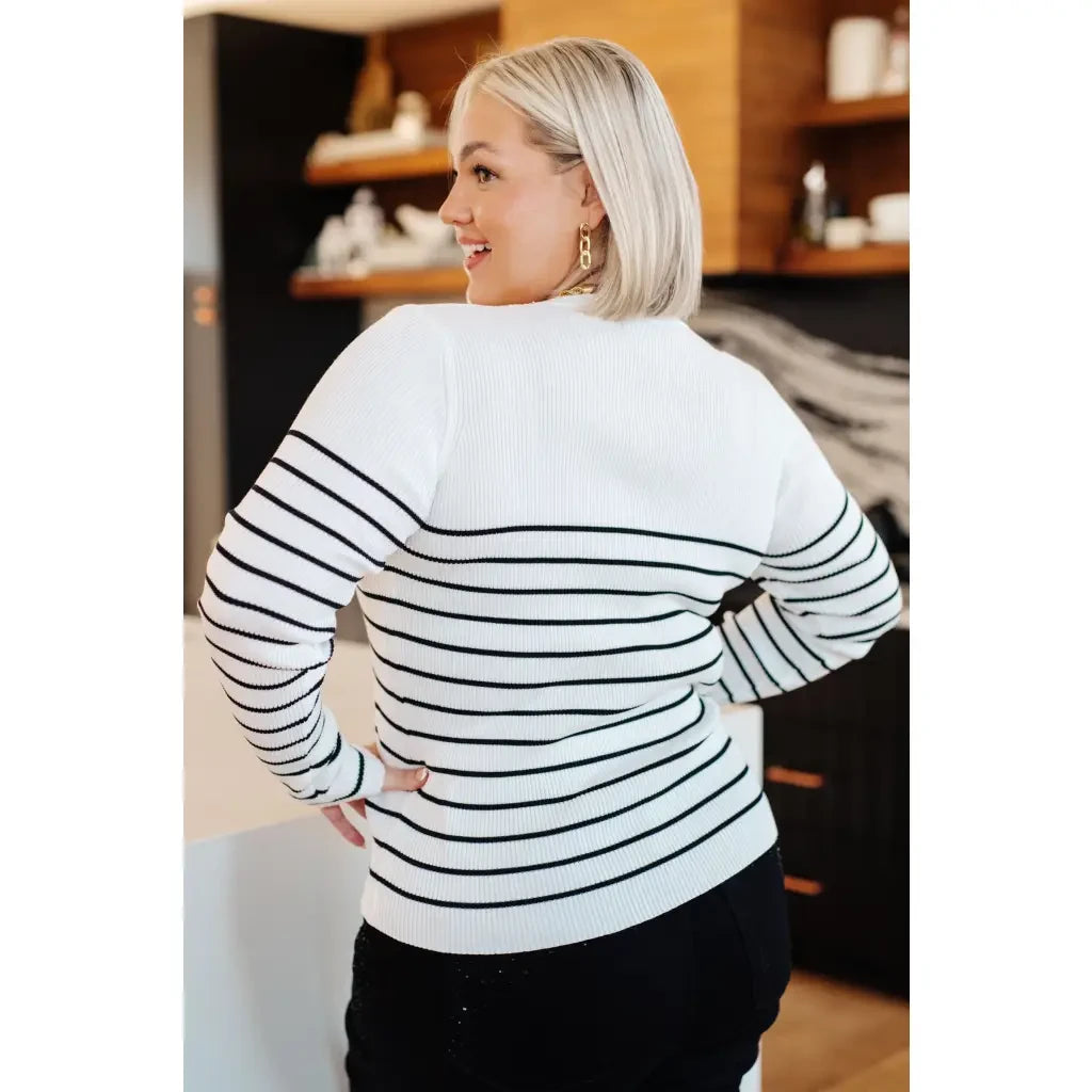 Our Be Still V-Neck Striped Sweater features a classic black and white stripe pattern that adds timeless versatile look