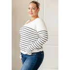 Our Be Still V-Neck Striped Sweater features a classic black and white stripe pattern that adds timeless versatile look