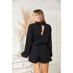 Our Black Open Back Romper with Pockets is the perfect combination of style and functionality. The high neck open back