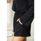 Our Black Open Back Romper with Pockets is the perfect combination of style and functionality. The high neck open back