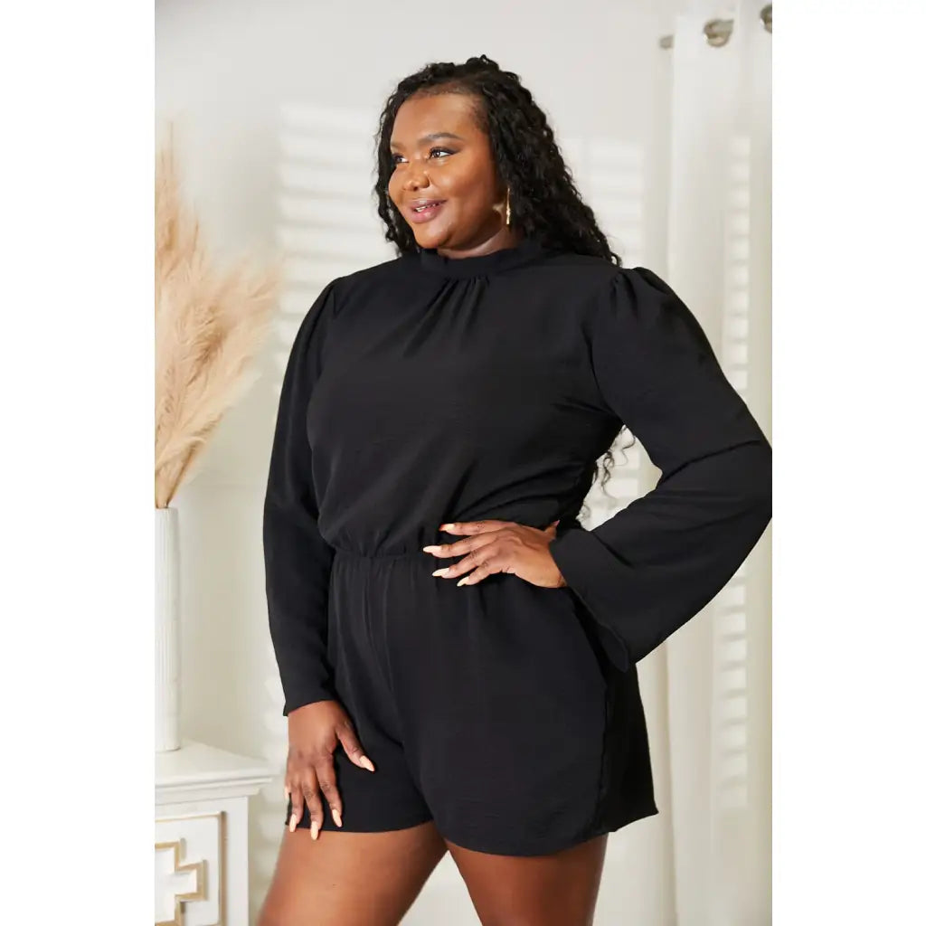 Our Black Open Back Romper with Pockets is the perfect combination of style and functionality. The high neck open back