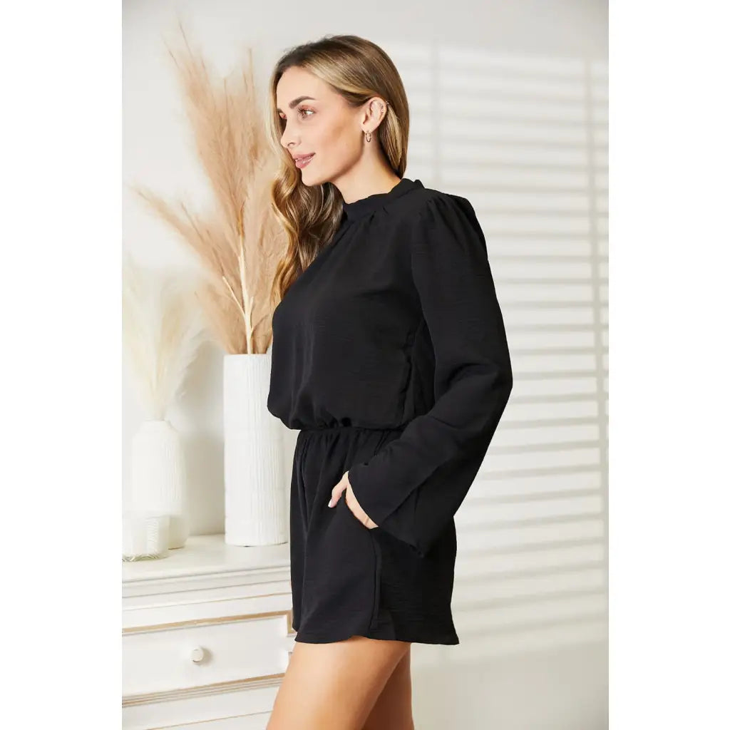 Our Black Open Back Romper with Pockets is the perfect combination of style and functionality. The high neck open back