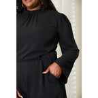 Our Black Open Back Romper with Pockets is the perfect combination of style and functionality. The high neck open back