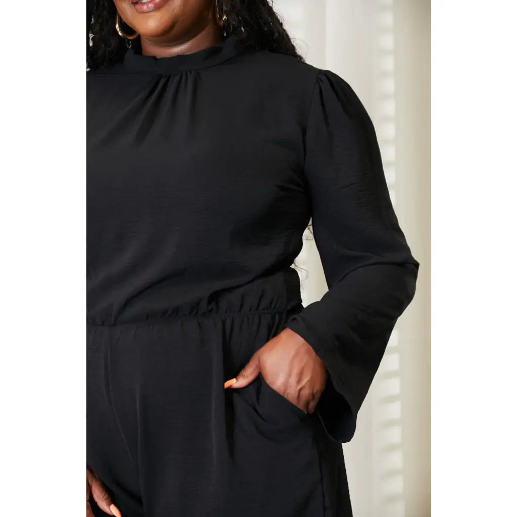 Our Black Open Back Romper with Pockets is the perfect combination of style and functionality. The high neck open back
