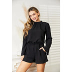Our Black Open Back Romper with Pockets is the perfect combination of style and functionality. The high neck open back