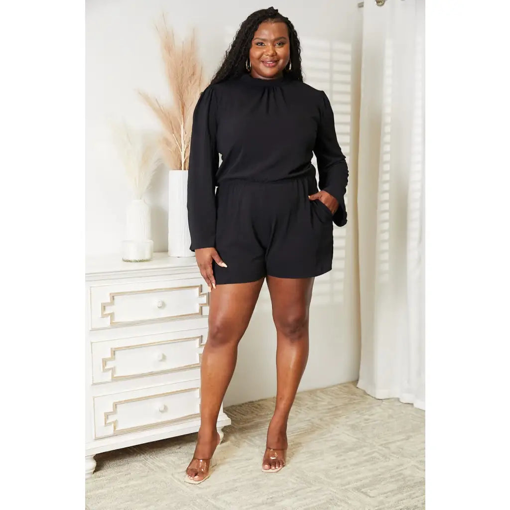 Our Black Open Back Romper with Pockets is the perfect combination of style and functionality. The high neck open back