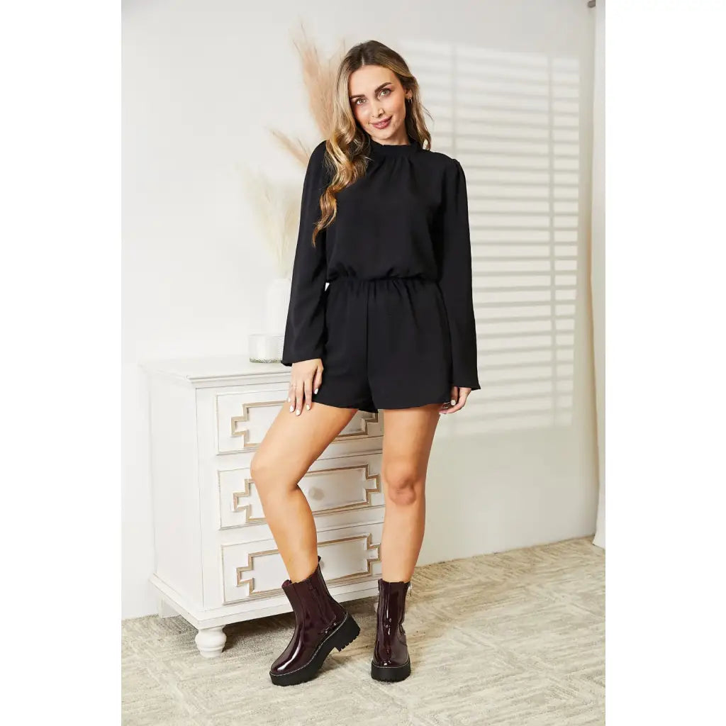 Our Black Open Back Romper with Pockets is the perfect combination of style and functionality. The high neck open back