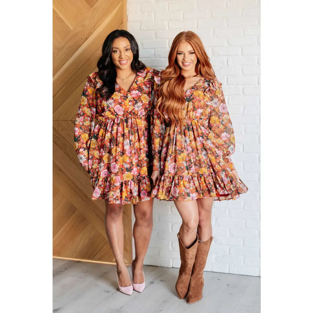 Our Boho Floral Balloon Sleeve Mini Dress is constructed in a playful chiffon material featuring v-neck ront buttons