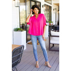 A bold flowy pink blouse with chic dolman sleeves and an oversized fit — plus it’s designed to flatter all sizes