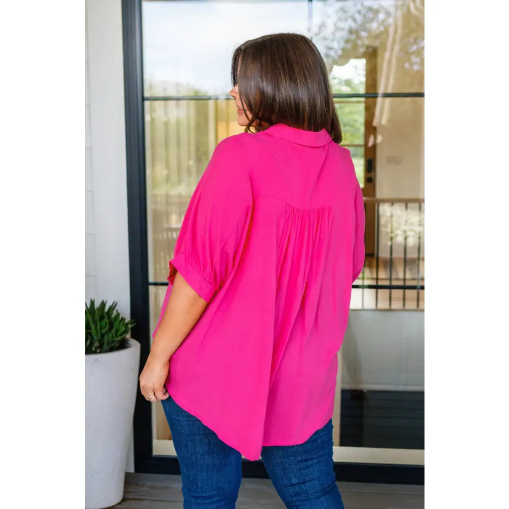 A bold flowy pink blouse with chic dolman sleeves and an oversized fit — plus it’s designed to flatter all sizes
