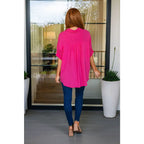 A bold flowy pink blouse with chic dolman sleeves and an oversized fit — plus it’s designed to flatter all sizes