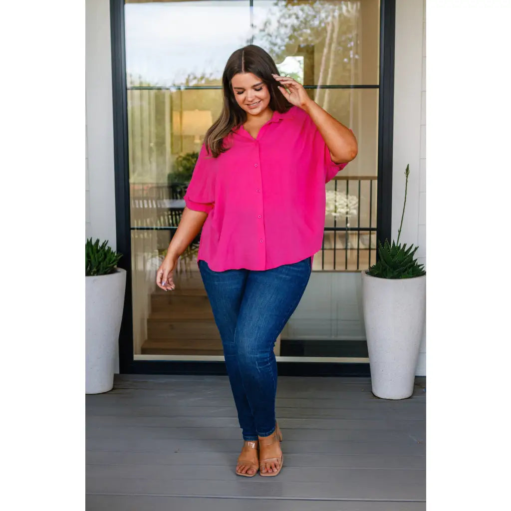 A bold flowy pink blouse with chic dolman sleeves and an oversized fit — plus it’s designed to flatter all sizes