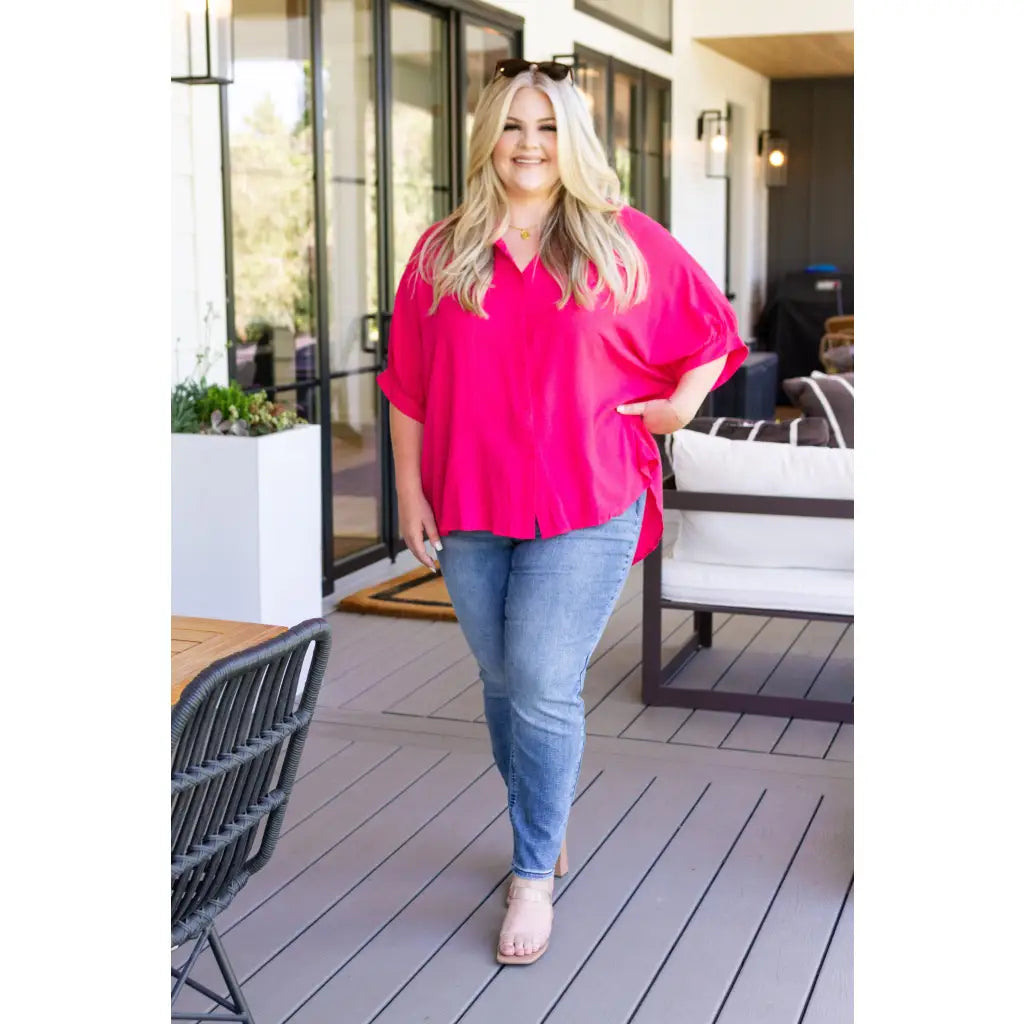 A bold flowy pink blouse with chic dolman sleeves and an oversized fit — plus it’s designed to flatter all sizes