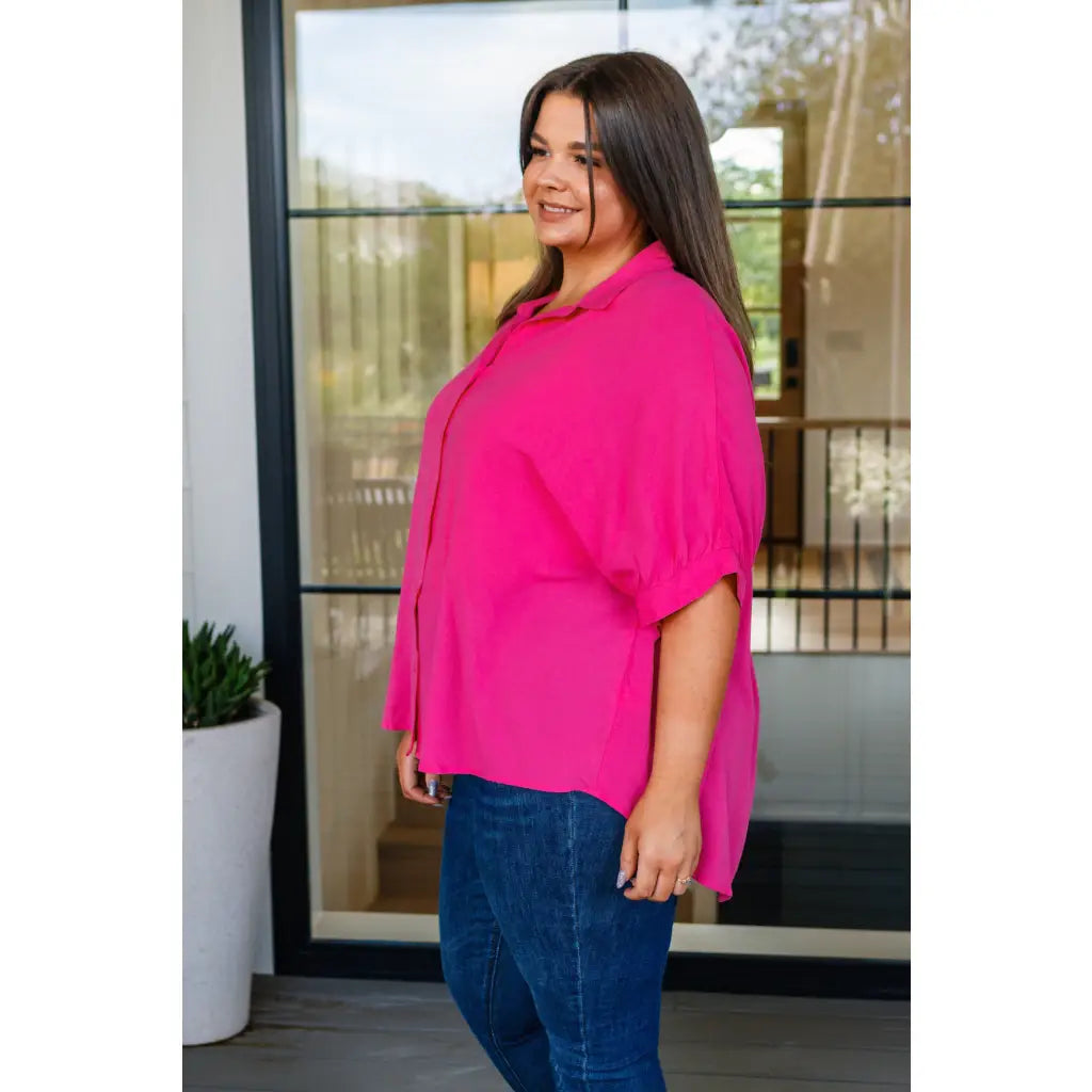 A bold flowy pink blouse with chic dolman sleeves and an oversized fit — plus it’s designed to flatter all sizes