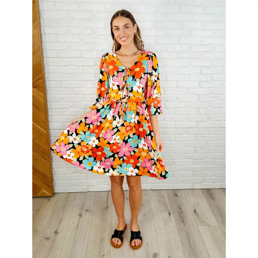 Make a statement in the Bow-dly Go V-Neck Floral Mini Dress. A bold playful vibrant boutique dress buttery soft fabric