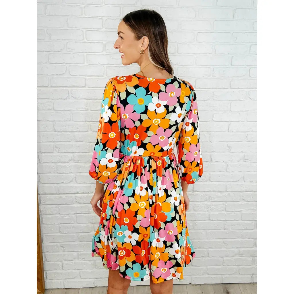 Make a statement in the Bow-dly Go V-Neck Floral Mini Dress. A bold playful vibrant boutique dress buttery soft fabric