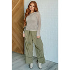 Our Calming Down Loose Knit Top in Beige offers lightweight comfort with its sheer layer and relaxed fit. Designed