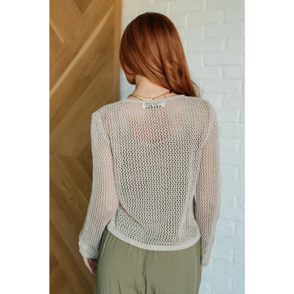 Our Calming Down Loose Knit Top in Beige offers lightweight comfort with its sheer layer and relaxed fit. Designed