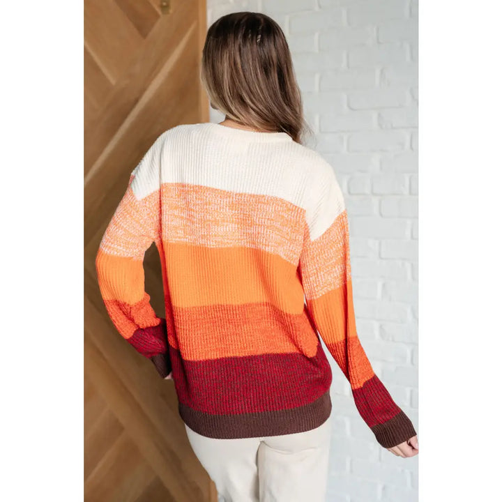 Our Candy Corn Color Block Wide Striped Sweater features a round neckline that adds touch of charm while the drop