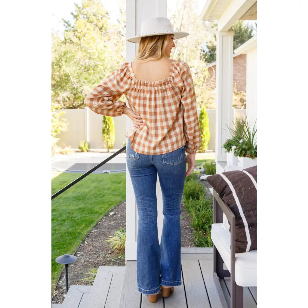 It’s easy to look cute and on trend in our Caramel Fall Gingham Plaid! This adorable top features an elasticated