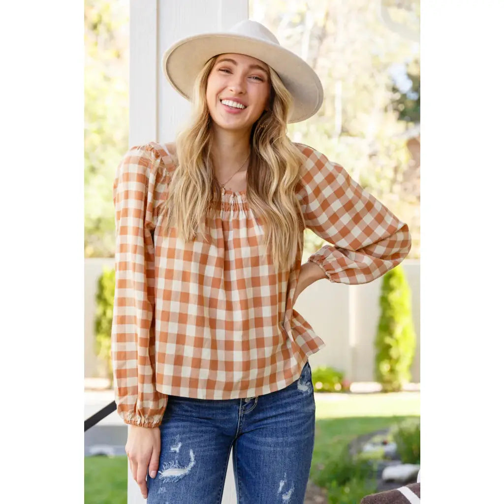 It’s easy to look cute and on trend in our Caramel Fall Gingham Plaid! This adorable top features an elasticated