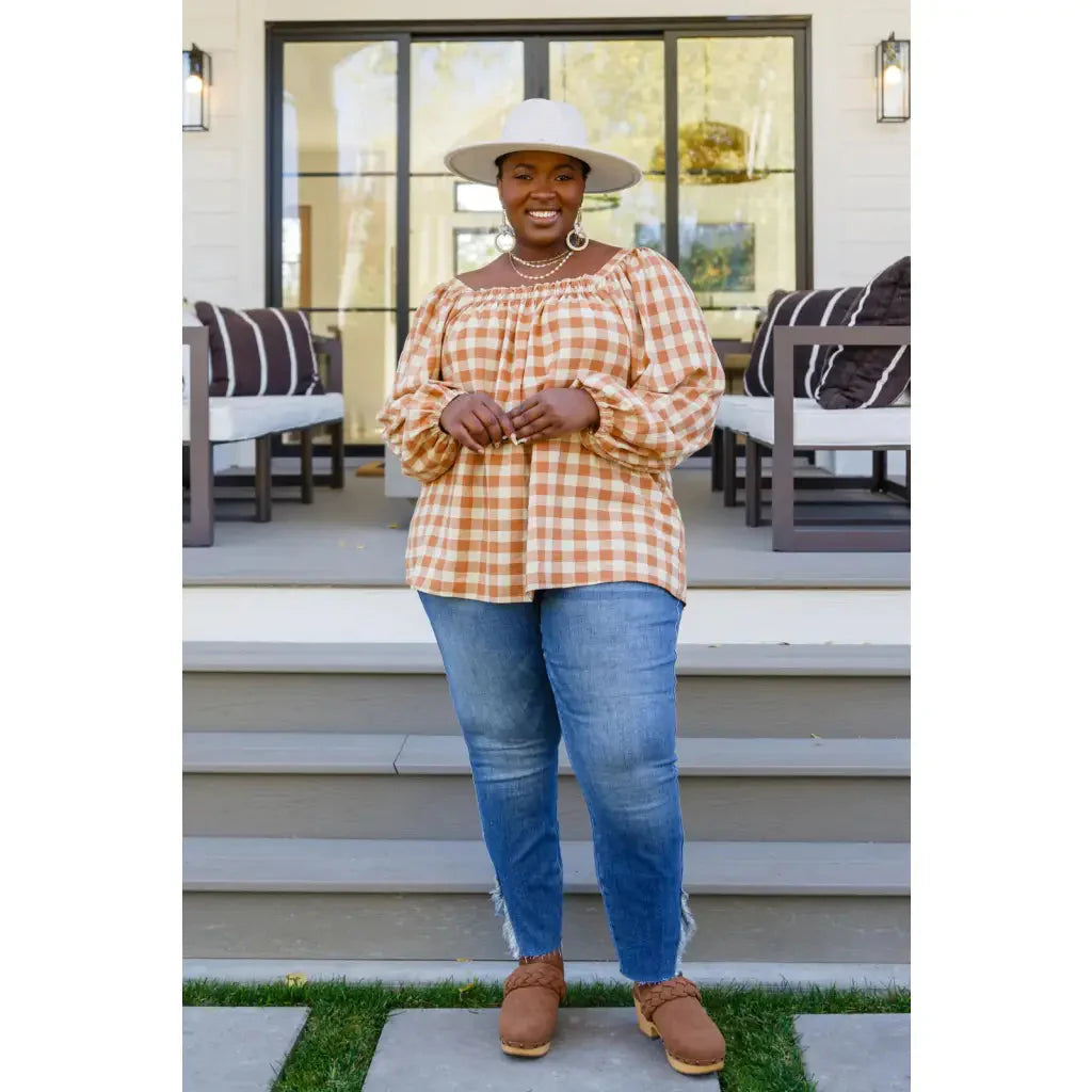 It’s easy to look cute and on trend in our Caramel Fall Gingham Plaid! This adorable top features an elasticated