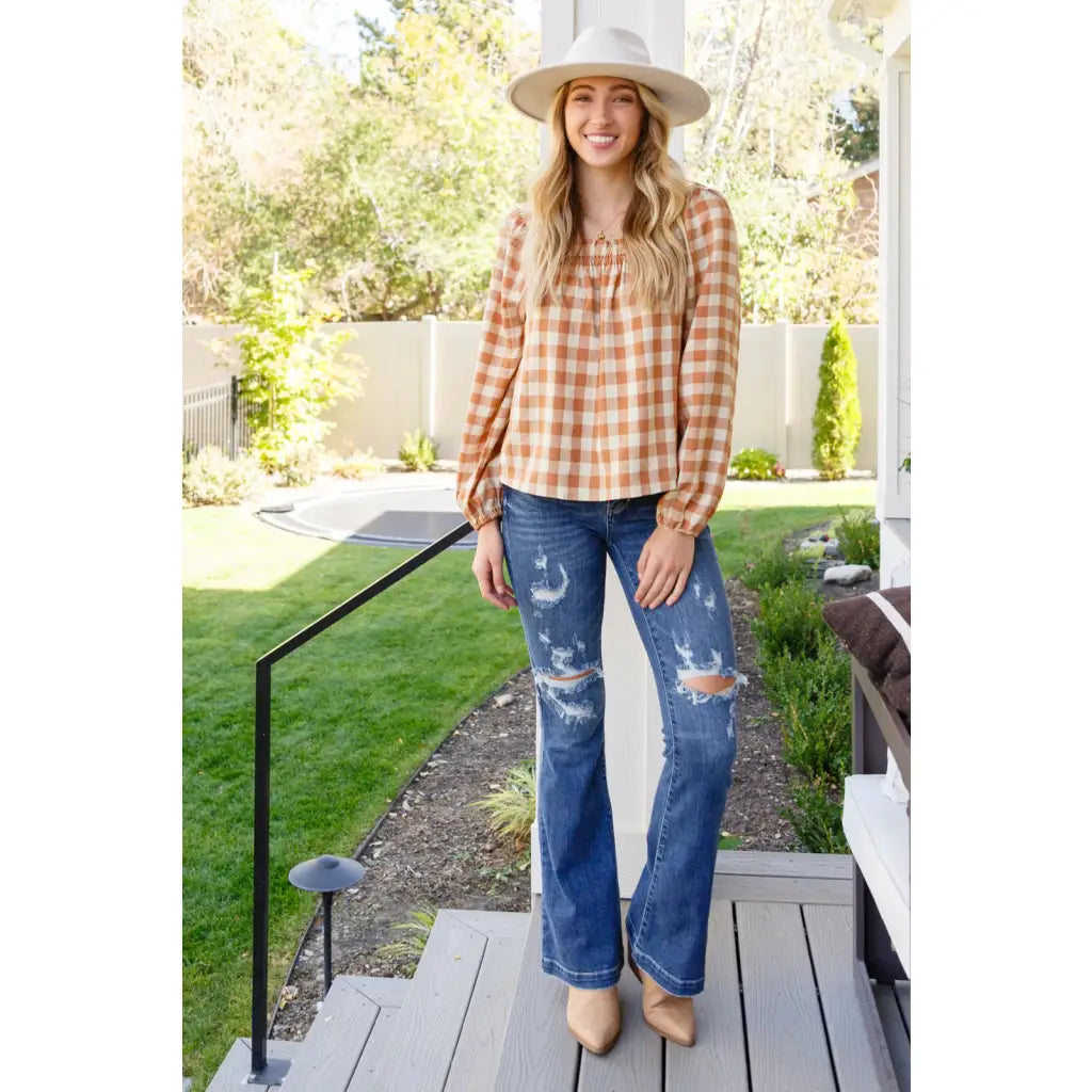 It’s easy to look cute and on trend in our Caramel Fall Gingham Plaid! This adorable top features an elasticated