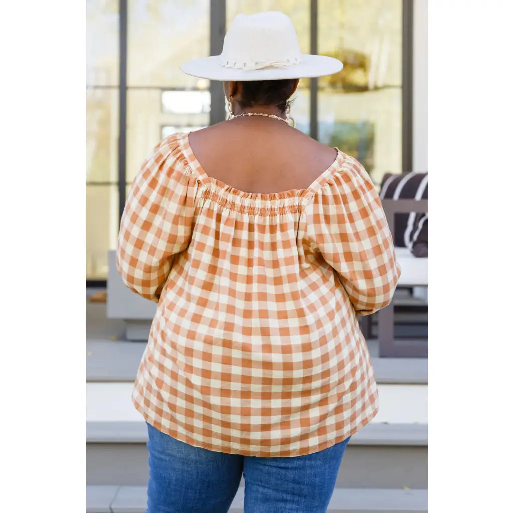 It’s easy to look cute and on trend in our Caramel Fall Gingham Plaid! This adorable top features an elasticated