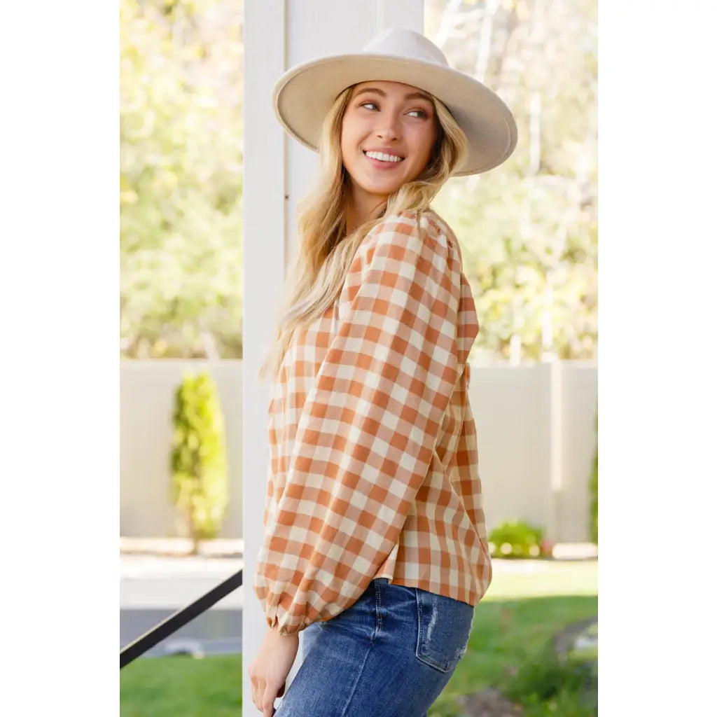 It’s easy to look cute and on trend in our Caramel Fall Gingham Plaid! This adorable top features an elasticated