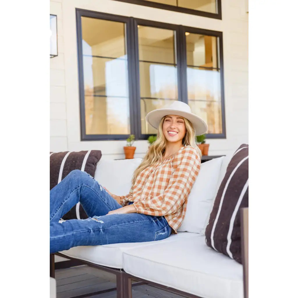 It’s easy to look cute and on trend in our Caramel Fall Gingham Plaid! This adorable top features an elasticated