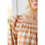 It’s easy to look cute and on trend in our Caramel Fall Gingham Plaid! This adorable top features an elasticated