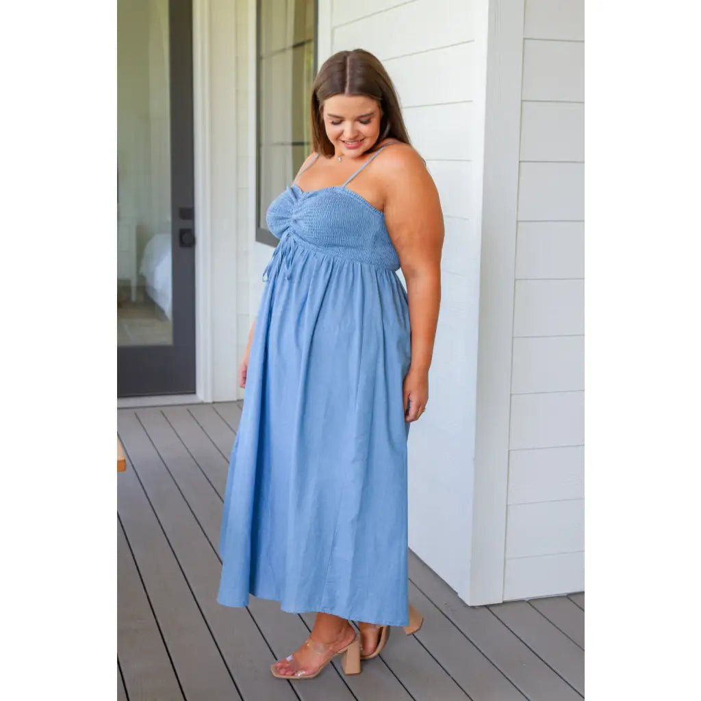 Feel the southern breeze in our Carolina My Mind Midi Dress! This lightweight denim dress features a smocked bust line