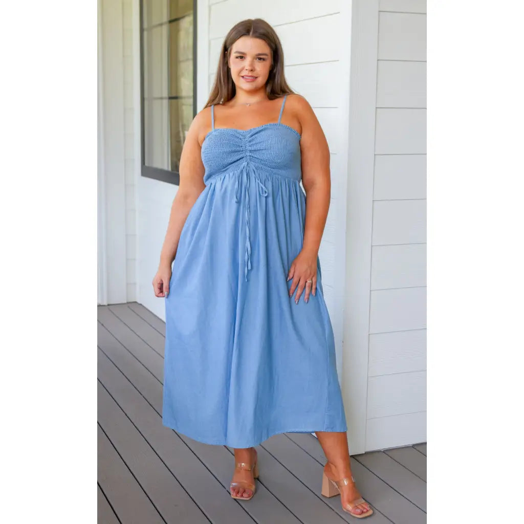 Feel the southern breeze in our Carolina My Mind Midi Dress! This lightweight denim dress features a smocked bust line