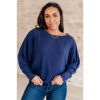 Stay cozy and chic with our Casually Comfy Batwing Top! Made soft brushed hacci navy fabric this boat neckline top